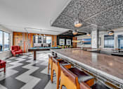 Thumbnail 27 of 41 - A black and white checkered floor in a room with a pool table.