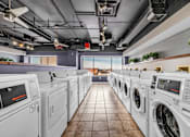 Thumbnail 37 of 41 - A row of washing machines in a laundromat.