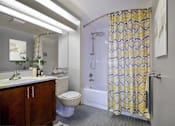 Thumbnail 10 of 44 - A bathroom with a toilet, sink, and shower.