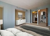 Thumbnail 8 of 44 - A bedroom with a bed, dresser, and mirror.