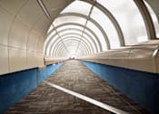 Thumbnail 24 of 41 - a tunnel with blue walls and white light at the end