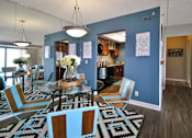 Thumbnail 3 of 41 - a dining room and kitchen with a glass table and chairs