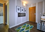 Thumbnail 12 of 41 - a living room with a rug and pictures on the wall