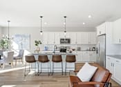 Thumbnail 2 of 44 - A modern kitchen with white cabinets and a central island.