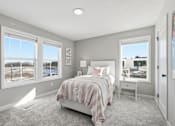 Thumbnail 27 of 44 - A bedroom with a large bed and a view of a snowy landscape outside the window.