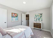 Thumbnail 26 of 44 - A bedroom with a bed, dresser, and two paintings on the wall.