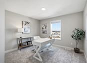 Thumbnail 28 of 44 - A room with a white desk and a plant.