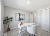 Thumbnail 29 of 44 - A white desk with a chair and a potted plant in a room with a painting on the wall.