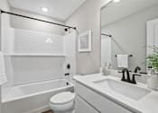 Thumbnail 34 of 44 - A white bathroom with a toilet, sink, and bathtub.