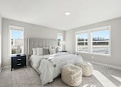 Thumbnail 21 of 44 - A bedroom with a large bed and a window overlooking a snowy landscape.