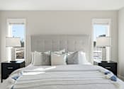 Thumbnail 22 of 44 - A bedroom with a large bed and two lamps.
