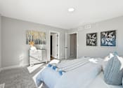 Thumbnail 24 of 44 - A bedroom with a bed, pillows, and two paintings on the wall.