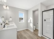 Thumbnail 31 of 44 - A bathroom with a white sink and a window.