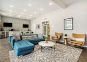 Thumbnail 20 of 26 - a living room with a blue couch and two chairs