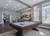 Thumbnail 23 of 26 - a games room with a pool table in a home with windows