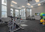 Thumbnail 22 of 26 - an indoor gym with exercise bikes and windows