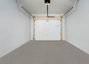 Thumbnail 19 of 26 - a garage with a white wall and a white door