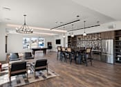 Thumbnail 13 of 18 - A modern kitchen with dark wood floors and a large island.
