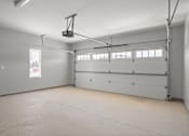 Thumbnail 11 of 18 - A spacious garage with a lift system installed.