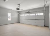 Thumbnail 9 of 28 - the interior of a garage with a white door