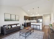 Thumbnail 3 of 28 - a living room with a couch and a table