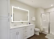 Thumbnail 6 of 28 - a white bathroom with a large mirror and a shower