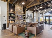 Thumbnail 16 of 28 - a lobby with couches and chairs and a stone fireplace