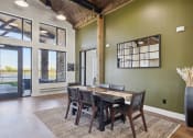 Thumbnail 18 of 28 - a dining room with a wooden table and chairs