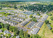 Thumbnail 25 of 42 - A bird's eye view of a residential area with houses and trees.