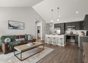 Thumbnail 9 of 31 - a living room with a couch and a table