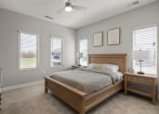 Thumbnail 10 of 31 - a bedroom with a bed and three windows