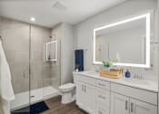 Thumbnail 13 of 31 - a white bathroom with a large mirror and a shower