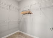 Thumbnail 12 of 31 - our spacious walk in closet has a large amount of hanging clothes
