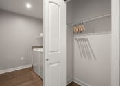 Thumbnail 15 of 31 - a laundry room with a washer and dryer and a white door