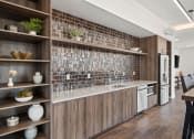 Thumbnail 21 of 31 - a kitchen with wooden cabinets and a counter top with a sink