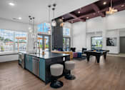 Thumbnail 14 of 53 - A kitchen with a bar area and a dining table.