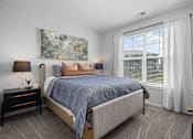 Thumbnail 7 of 53 - A bedroom with a large bed and a painting on the wall.