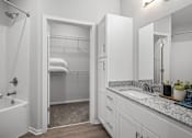 Thumbnail 10 of 53 - A white bathroom with a walk-in shower and a sink.