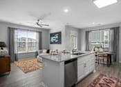 Thumbnail 2 of 53 - A modern kitchen with a large island and a dining area.