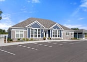 Thumbnail 32 of 53 - A building with a parking lot in front of it.