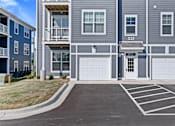 Thumbnail 30 of 53 - Apartment building with garage doors and number 332 on the front.