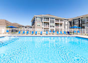 Thumbnail 52 of 53 - A large swimming pool in front of a resort building.
