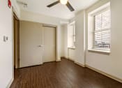 Thumbnail 7 of 16 - A room with a brown door and a ceiling fan.