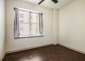 Thumbnail 9 of 16 - A room with a window and a ceiling fan.