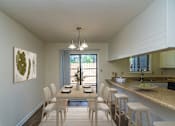 Thumbnail 4 of 32 - A dining room with a table set for four.