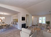 Thumbnail 2 of 32 - A living room with a fireplace and a dining table.