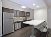Thumbnail 13 of 32 - a kitchen with stainless steel appliances and a white counter top