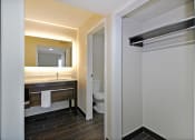 Thumbnail 23 of 32 - a bathroom with a toilet and a sink and a mirror