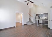 Thumbnail 12 of 32 - the living room and kitchen of a new home with a ceiling fan