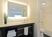 Thumbnail 24 of 32 - a bathroom with a sink and a mirror in a hotel room